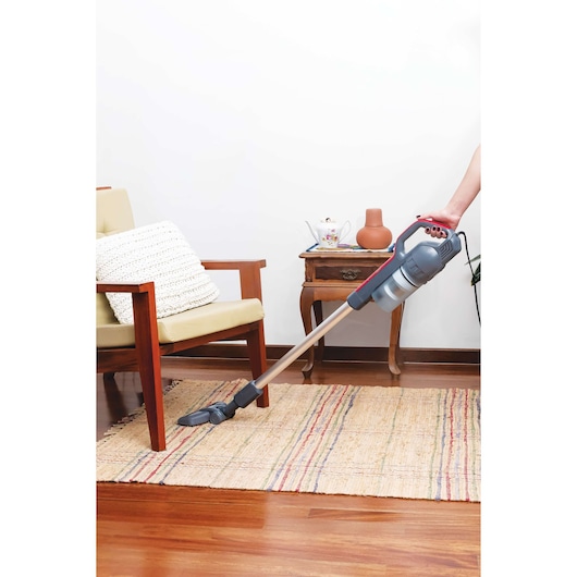 Photo of BLACKDECKER AVT12 cordless vacuum cleaner on rug in living room setting.