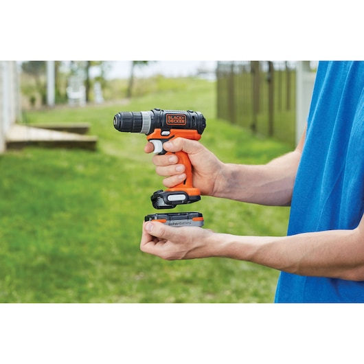 BLACKDECKER BCB001K cordless drill with GoPak battery held outdoors, product category Photography.