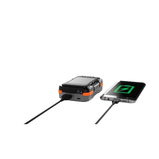 BLACKDECKER BCB001K battery pack charging a smartphone via USB, angled view, on white background.