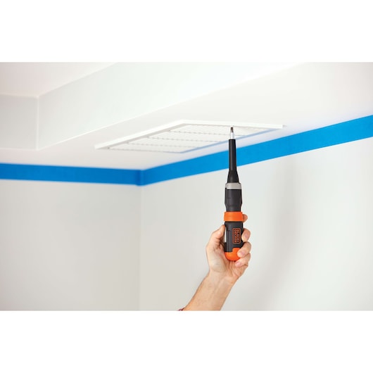BLACKDECKER BCF601AA cordless screwdriver with extension used to install ceiling vent, photography side angle