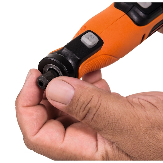 Photo of BLACKDECKER BCRT8K35 rotary tool close-up, orange handle, hand adjusting the chuck, white background