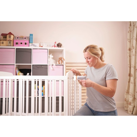 BLACKDECKER BCRTA01 handheld tool used in nursery, white crib and pink storage cubes in background.