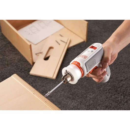 BLACKDECKER BCRTA01 cordless screwdriver, white and orange, used for furniture assembly, side angle.