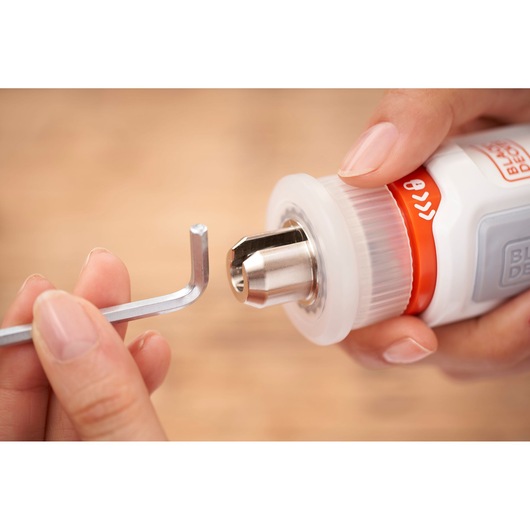 Close-up of BLACKDECKER BCRTA01 tool with hex key being inserted into metal chuck.
