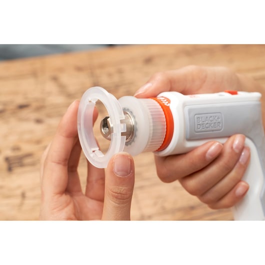 Photo of BLACKDECKER BCRTA01 tool in hand, close-up showing attachment being fitted.