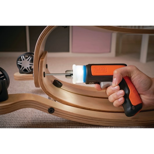 BLACKDECKER BCRTA601I cordless screwdriver in use assembling wooden furniture, close-up photography.