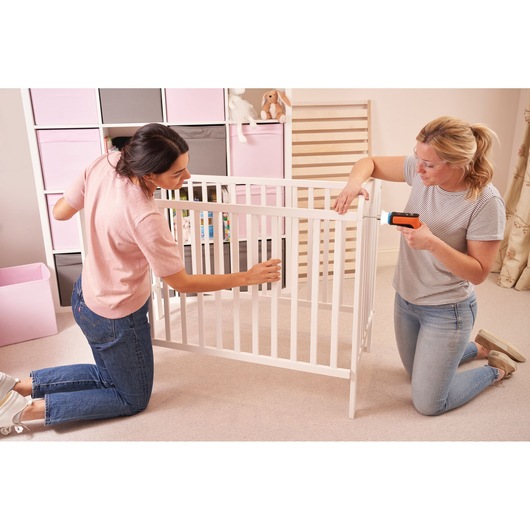 Photo of BLACKDECKER BCRTA601I cordless screwdriver used to assemble a white crib in a nursery.