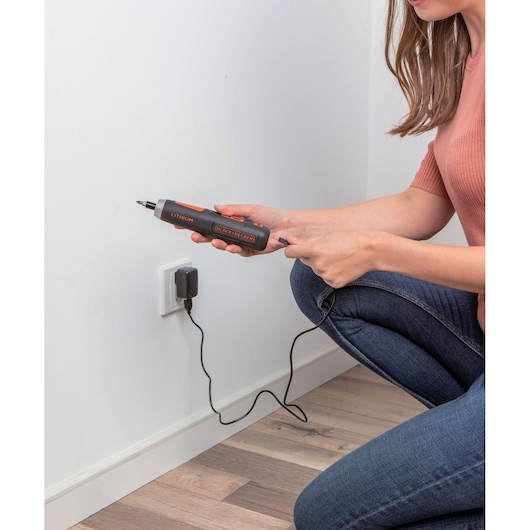 Photo of BLACKDECKER BD40K27 cordless screwdriver being charged on wall socket.