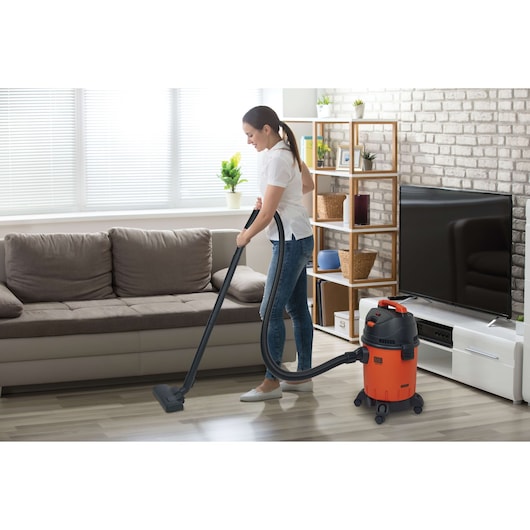 Photo of BLACKDECKER BDWD15 wet and dry vacuum cleaner used on hardwood floor in a living room.