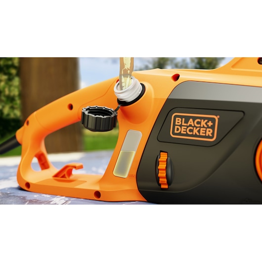 Photo of BLACK+DECKER chainsaw BECS2040 oil filling, close-up view showing handle and oil cap.