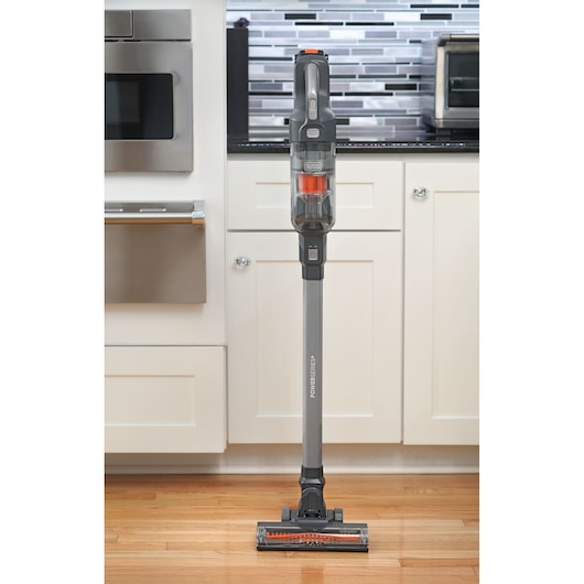 BLACKDECKER BHFEA18D1 cordless stick vacuum cleaner standing upright on a kitchen floor, front angle.
