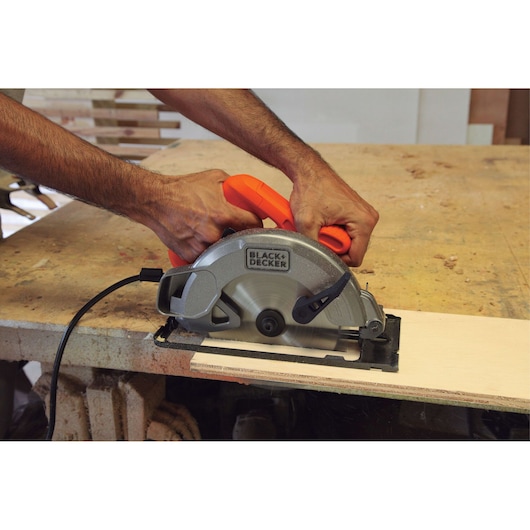 Photo of BLACKDECKER CS1004 circular saw used to cut wood on a workbench.